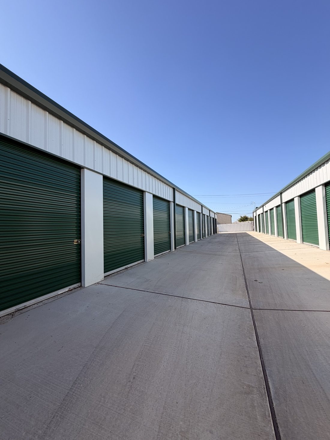 Drive-up storage units with green roll-up doors at A-1 Self Storage, 2620 W Pafford St, Fort Worth