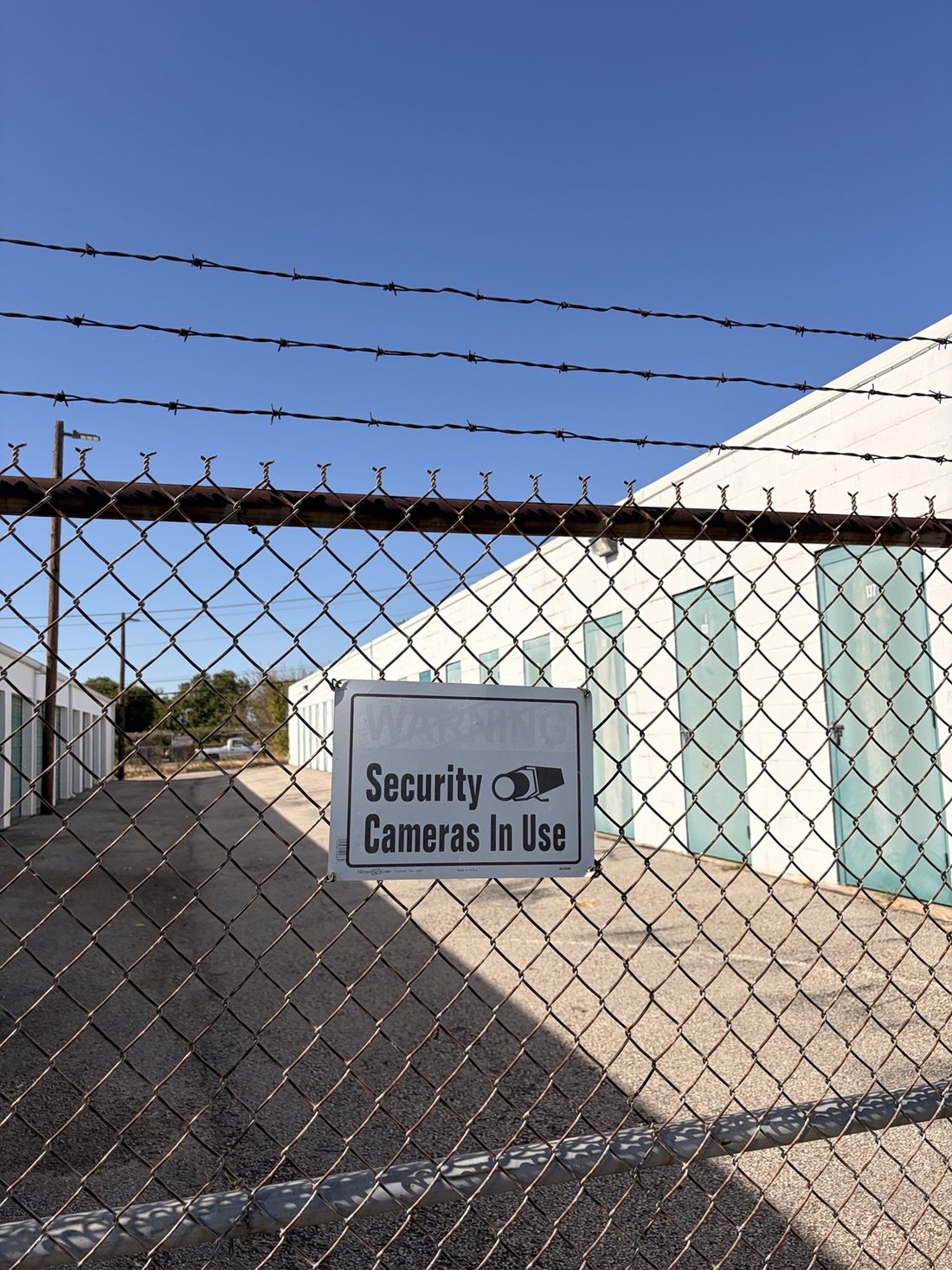 Security camera signage posted at A-Thrifti Self Storage on 8th Avenue in Fort Worth