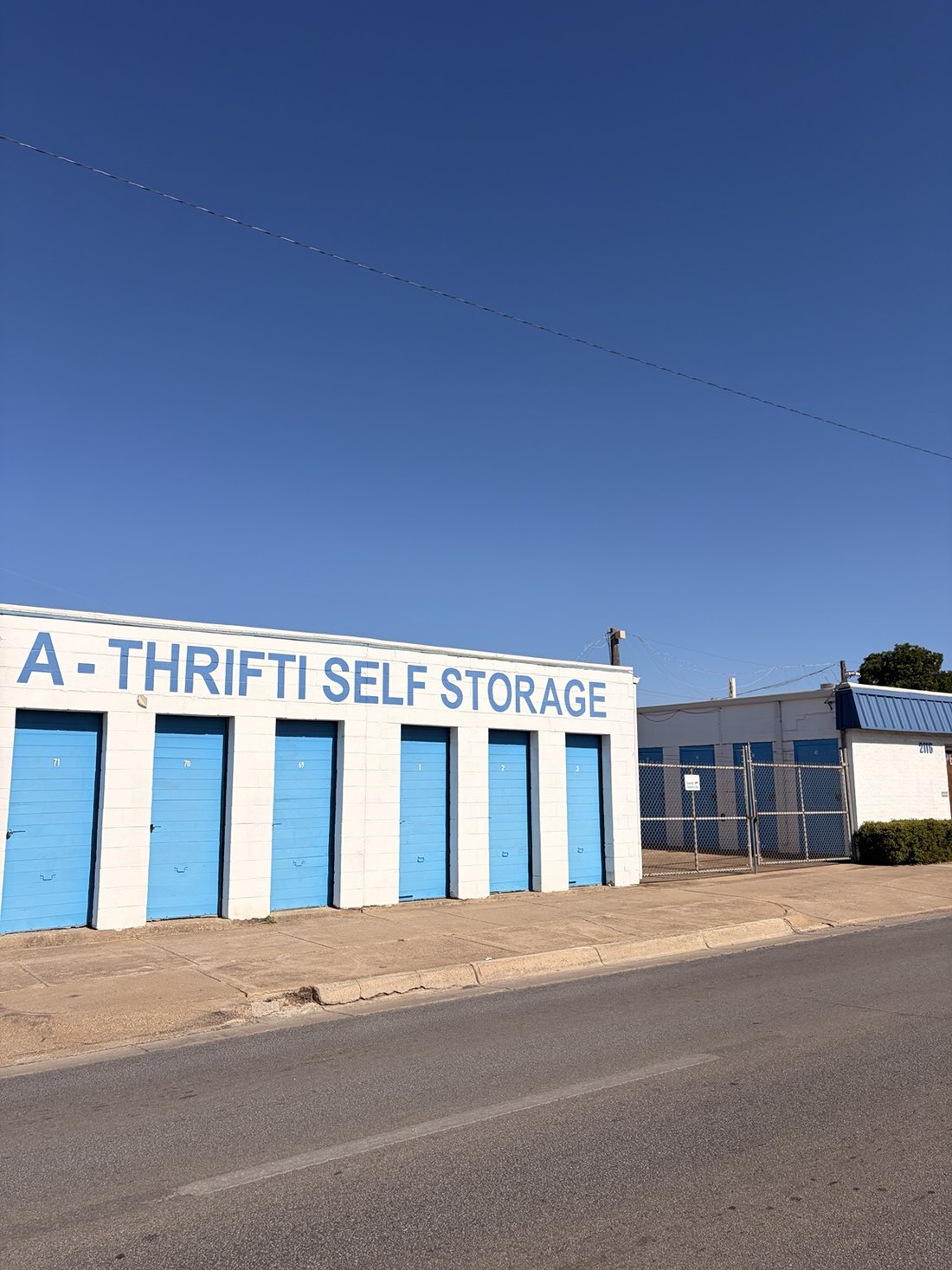 Fenced entrance to the A-Thrifti Self Storage property at 2115 8th Ave, Fort Worth